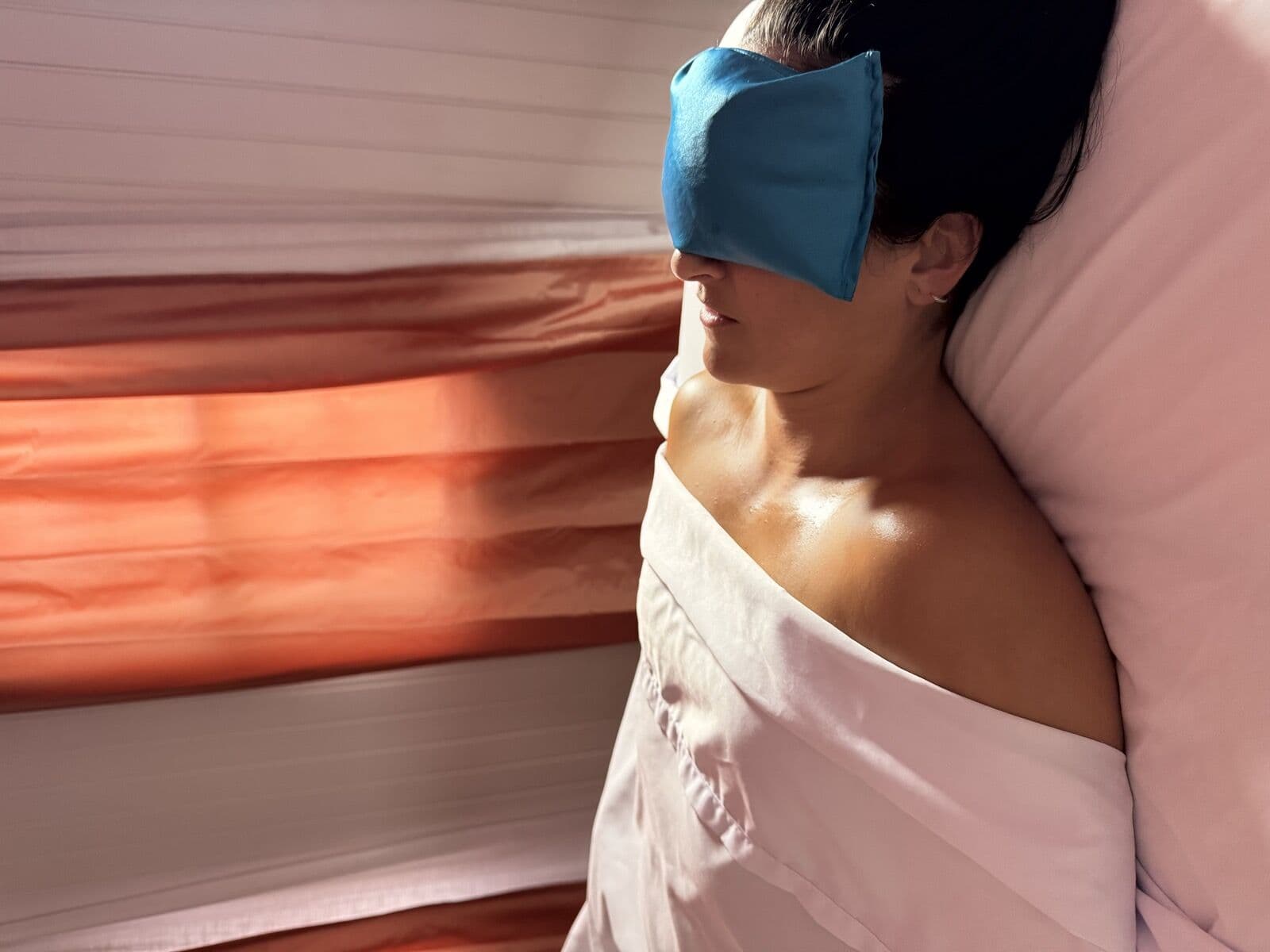 Guest resting under a warm eye pillow